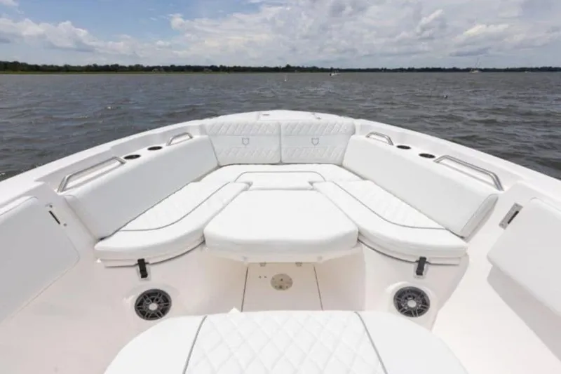 Slide: The Image of 2026 Sea Fox 268 Commander boat interior with white cushioned seating on open water. - 100