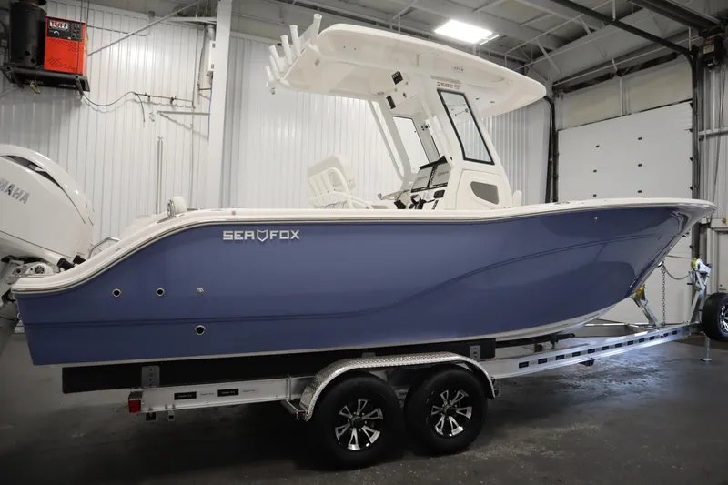 Slide: The Image of 2026 Sea Fox 268 Commander boat in a garage on a trailer. - 3