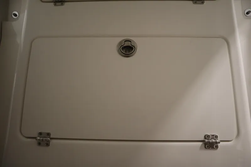 Slide: The Image of 2026 Sea Fox 268 Commander storage compartment with secure latch and hinges. - 31