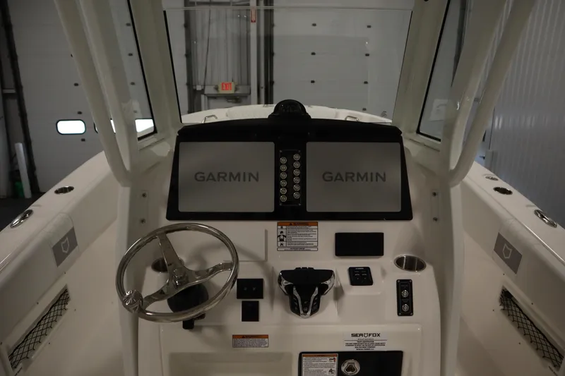 Slide: The Image of 2026 Sea Fox 268 Commander boat dashboard with Garmin navigation system and steering wheel. - 36