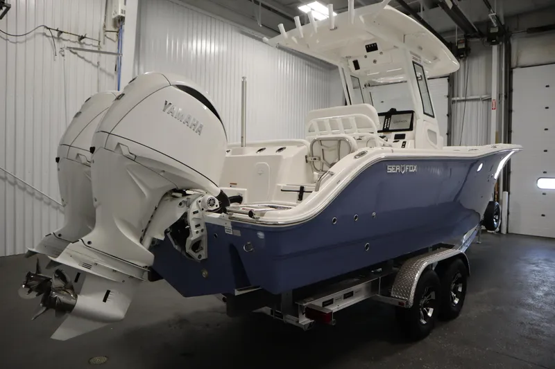 Slide: The Image of 2026 Sea Fox 268 Commander boat with Yamaha engines in a garage setting. - 4