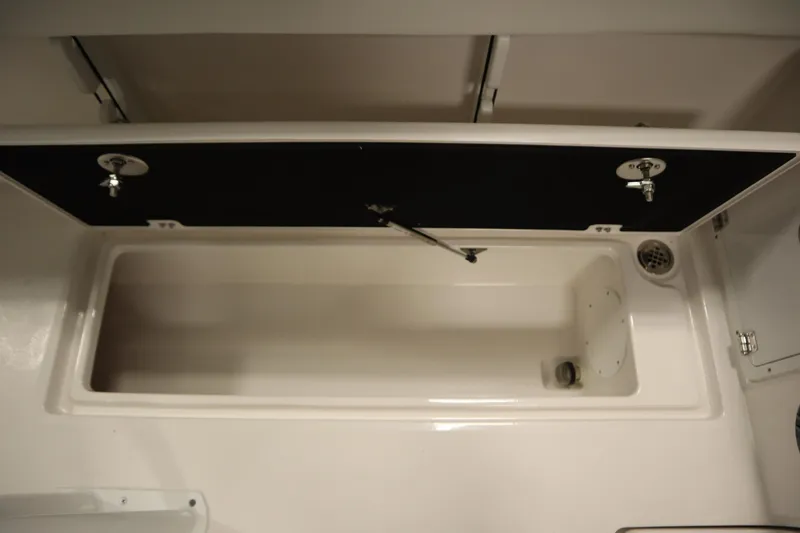 Slide: The Image of 2026 Sea Fox 268 Commander storage compartment with open lid and drainage system. - 55