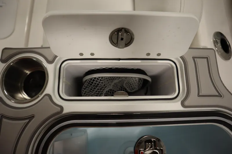 Slide: The Image of 2026 Sea Fox 268 Commander boat storage compartment with netting and cup holder. - 59