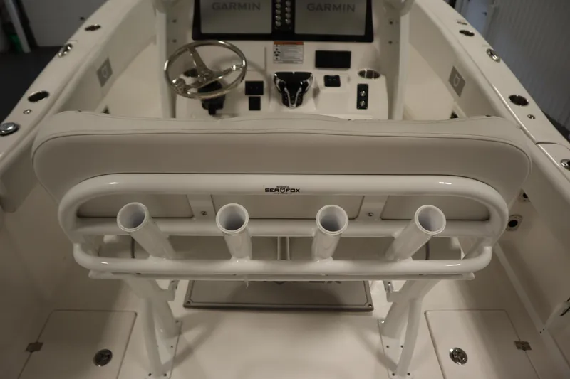 Slide: The Image of 2026 Sea Fox 268 Commander boat cockpit with steering wheel and rod holders. - 65