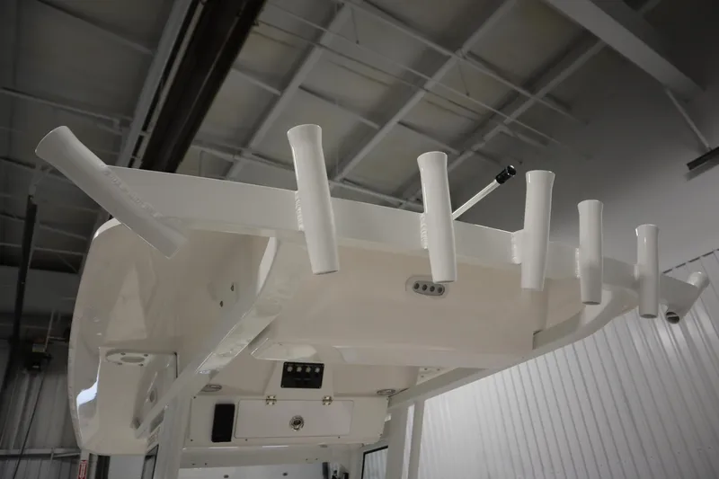 Slide: The Image of 2026 Sea Fox 268 Commander boat with rod holders in a warehouse setting. - 66