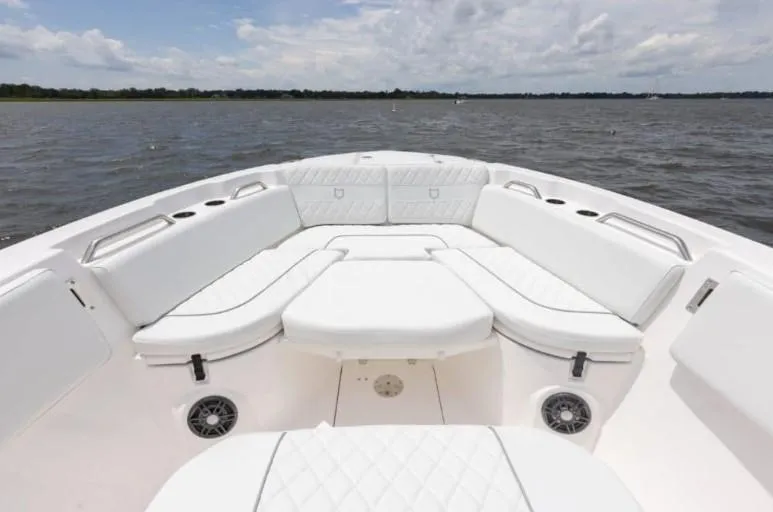 Slide: The Image of 2026 Sea Fox 268 Commander boat interior with white cushioned seating on open water. - 88