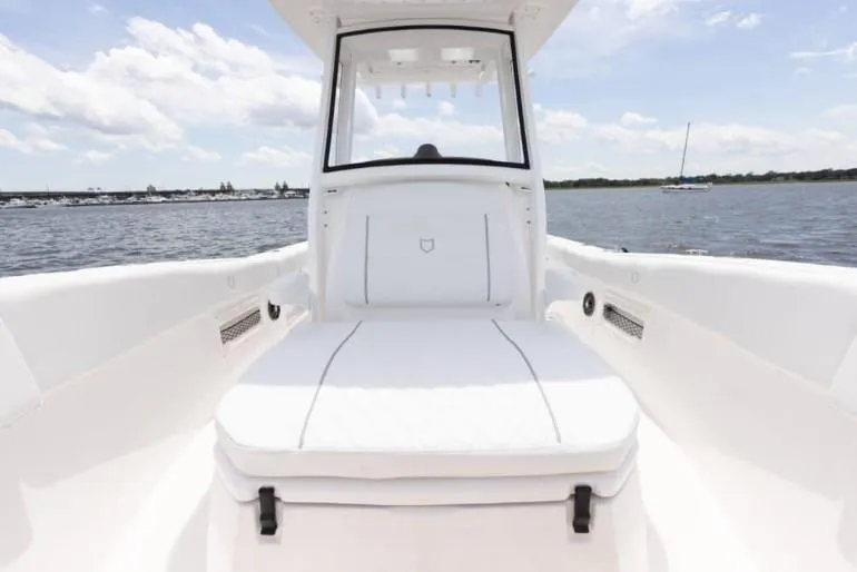 Slide: The Image of 2026 Sea Fox 268 Commander boat interior with white seating, on a sunny day. - 90