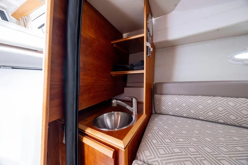 Slide: The Image of 2020 Cutwater C-24 interior with compact sink and cozy seating area. - 20