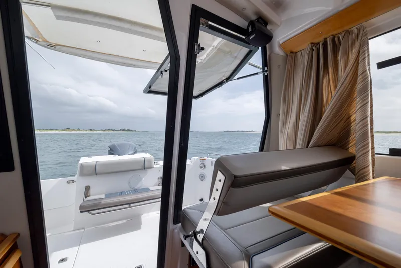 Slide: The Image of Interior view of 2020 Cutwater C-24 boat with open door to ocean. - 22