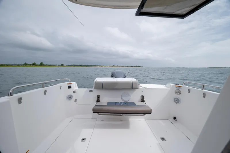Slide: The Image of 2020 Cutwater C-24 boat interior with ocean view, featuring a sleek seating area. - 24