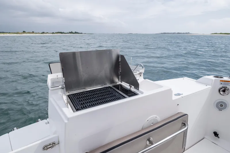 Slide: The Image of 2020 Cutwater C-24 boat with onboard grill, cruising on open water. - 29