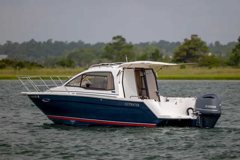 Slide: The Image of 2020 Cutwater C-24 boat with Yamaha engine on a serene lake. - 3