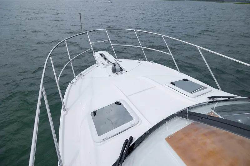 Slide: The Image of 2020 Cutwater C-24 boat deck on open water, showcasing sleek design and railing. - 30