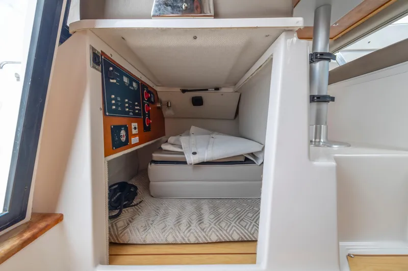 Slide: The Image of 2020 Cutwater C-24 interior storage with control panel and folded items. - 31
