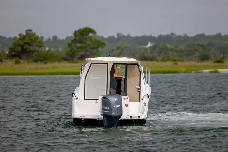 Slide: The Image of 2020 Cutwater C-24 boat cruising on a lake with Yamaha outboard motor. - 4