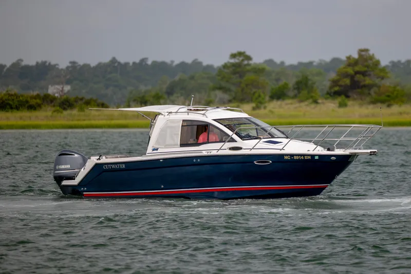 Slide: The Image of 2020 Cutwater C-24 boat cruising on a lake with Yamaha engine. - 5