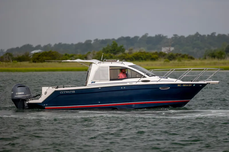 Slide: The Image of 2020 Cutwater C-24 boat cruising on water with Yamaha outboard motor. - 6