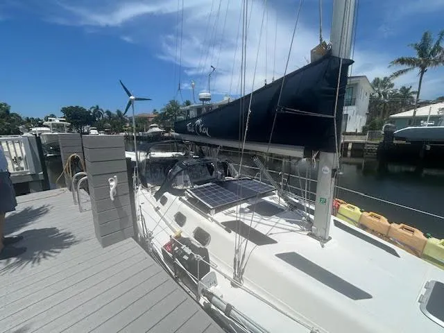Slide: The Image of Sailboat docked with solar panels, Hunter 35 model, 1987, named "Teak Key". - 2