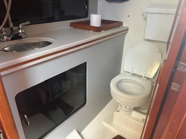 Slide: The Image of Compact kitchen area in a 1987 Hunter 35 sailboat with sink and storage. - 21