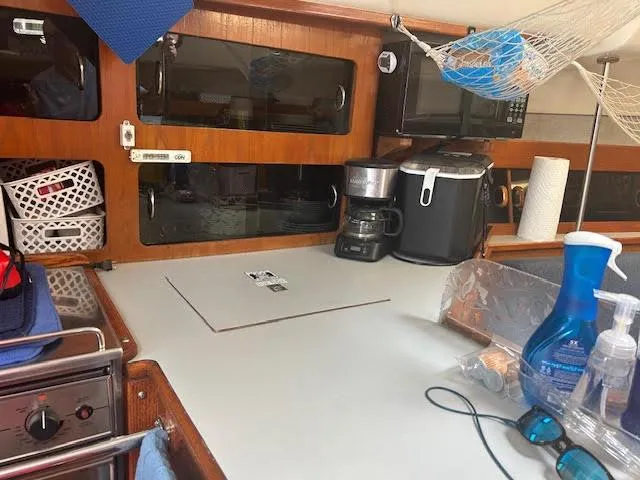 Slide: The Image of 1987 Hunter 35 boat bathroom with sink, toilet, and storage cabinet. - 22