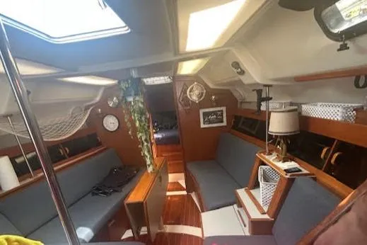 Slide: The Image of Wooden interior of 1987 Hunter 35 sailboat with cup holders and storage cabinet. - 24