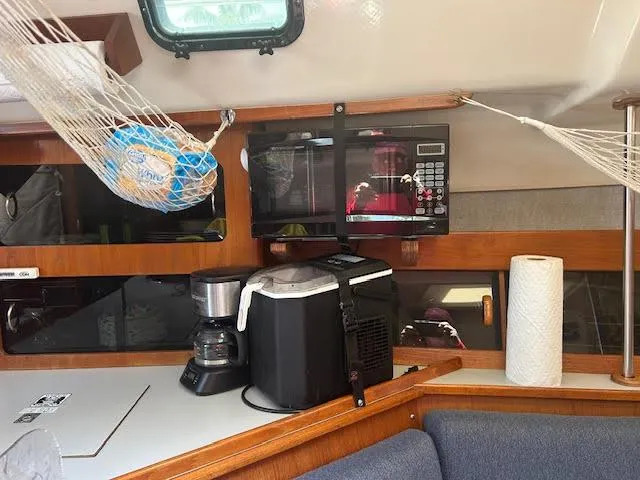 Slide: The Image of Interior of a 1987 Hunter 35 sailboat with kitchen appliances and storage. - 25
