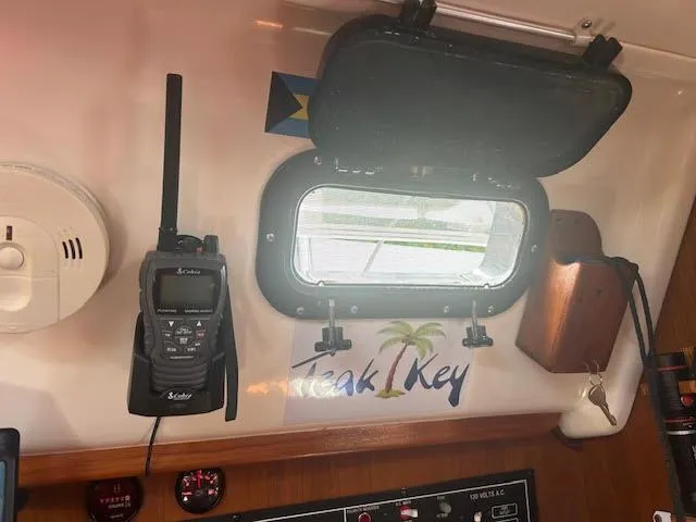 Slide: The Image of Interior of a 1987 Hunter 35 sailboat with radio, window, and "Teak Key" sticker. - 28