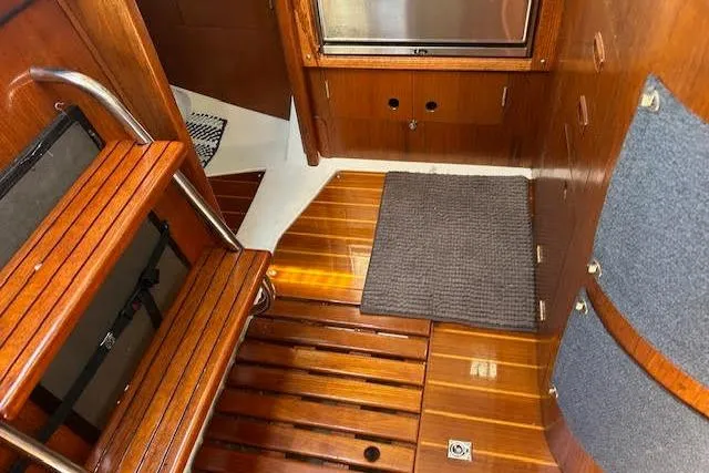 Slide: The Image of Interior of 1987 Hunter 35 sailboat with wooden flooring and steps. - 43