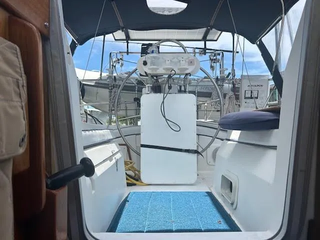 Slide: The Image of 1987 Hunter 35 sailboat docked, featuring solar panels and "Teak Key" branding. - 5