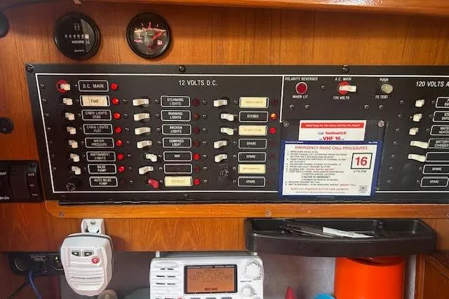 Slide: The Image of Electrical control panel on a 1987 Hunter 35 sailboat, featuring switches and gauges. - 51