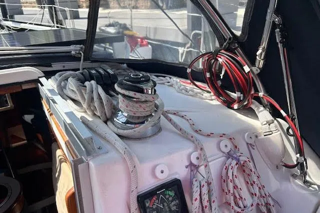 Slide: The Image of Cockpit of 1987 Hunter 35 sailboat with winch, ropes, and navigation instruments. - 67