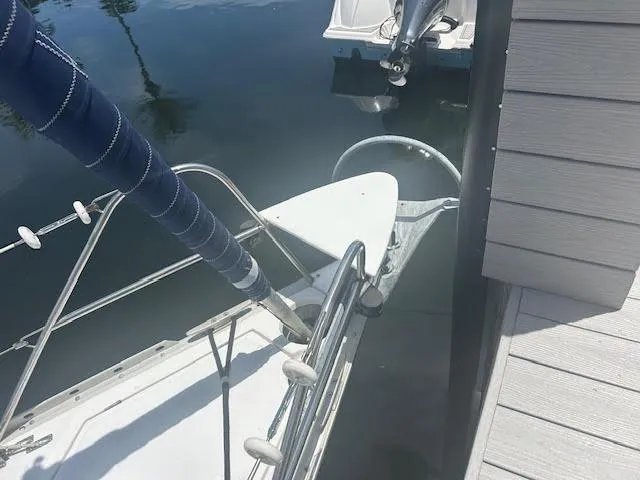 Slide: The Image of Bow of 1987 Hunter 35 sailboat docked, featuring anchor and railing. - 74