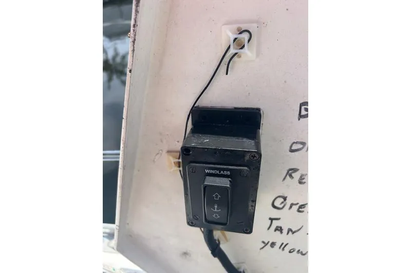 Slide: The Image of Windlass switch on a 1987 Hunter 35 sailboat with visible wiring and handwritten notes. - 75