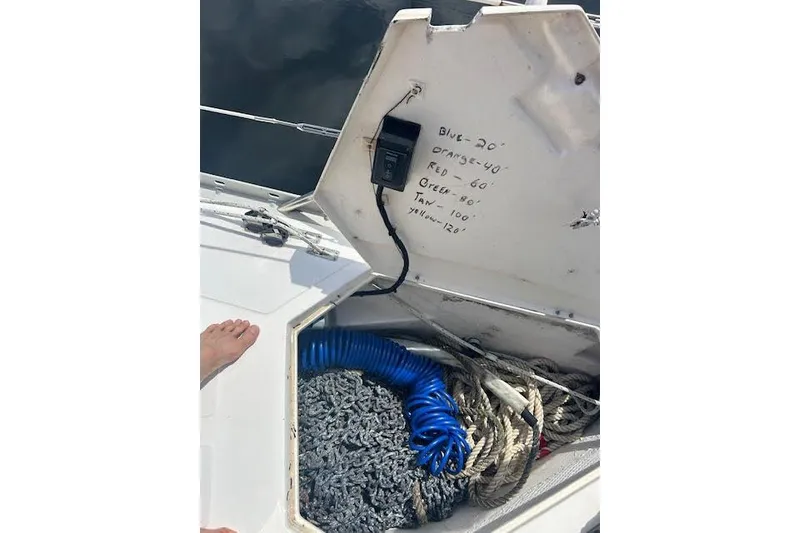 Slide: The Image of Open storage compartment on 1987 Hunter 35 sailboat with ropes and hose inside. - 77