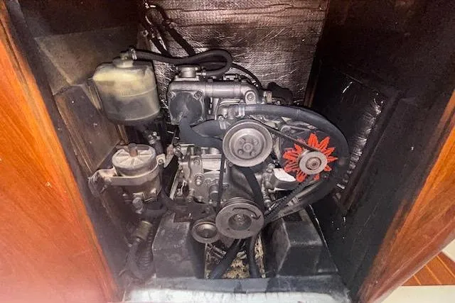 Slide: The Image of Engine compartment of a 1987 Hunter 35 sailboat, showcasing mechanical components and belts. - 78