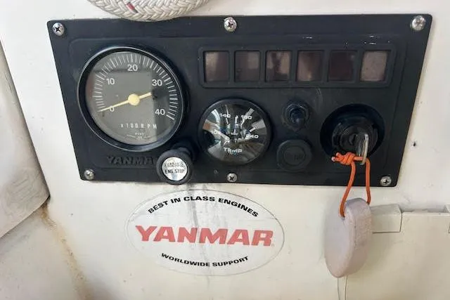 Slide: The Image of 1987 Hunter 35 sailboat cockpit with ropes, winch, and navigation equipment. - 9