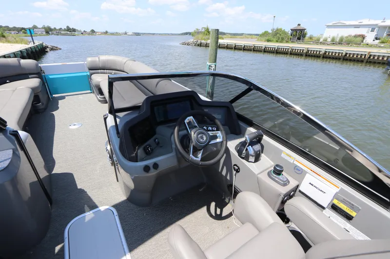 Slide: The Image of 2022 Tahoe Pontoon Grand Tahoe Twin Elite M2785 interior with steering console on a sunny day. - 12