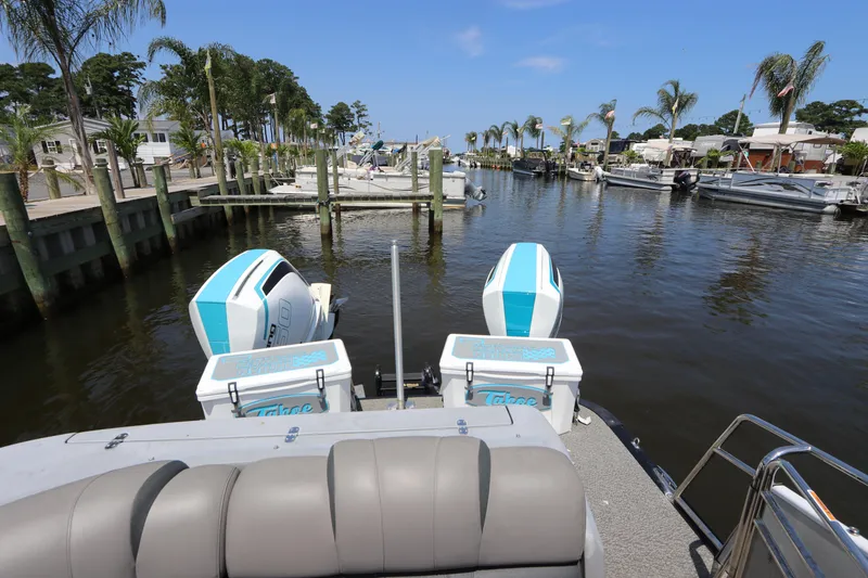 Slide: The Image of 2022 Tahoe Pontoon Grand Tahoe Twin Elite M2785 docked in a scenic marina. - 14