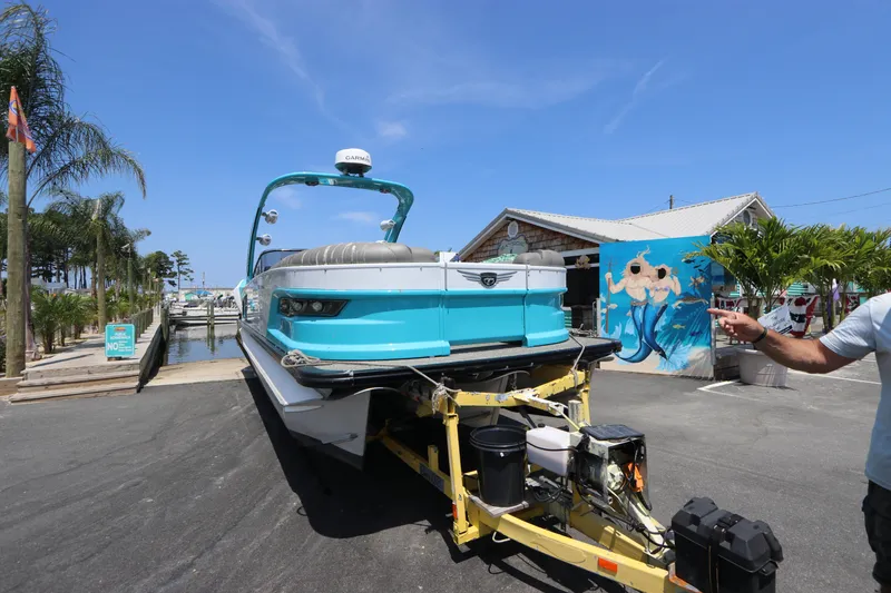 Slide: The Image of 2022 Tahoe Pontoon Grand Tahoe Twin Elite M2785 on trailer at marina, sunny day. - 2