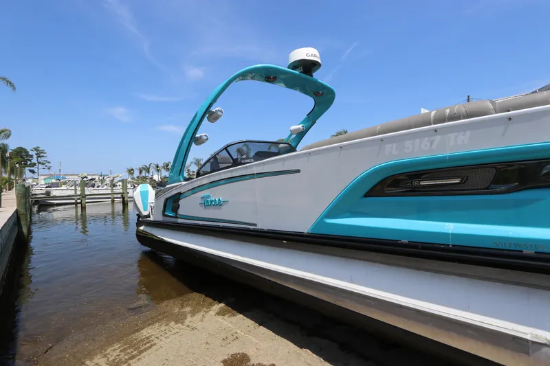 Slide: The Image of 2022 Tahoe Pontoon Grand Tahoe Twin Elite M2785 docked at marina under clear blue sky. - 5