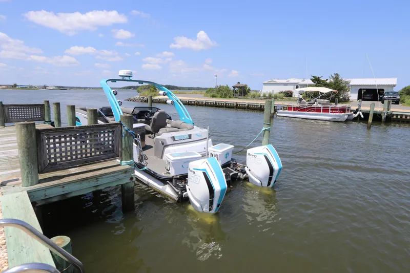 Slide: The Image of 2022 Tahoe Pontoon Grand Tahoe Twin Elite M2785 docked at a serene lakeside pier. - 6