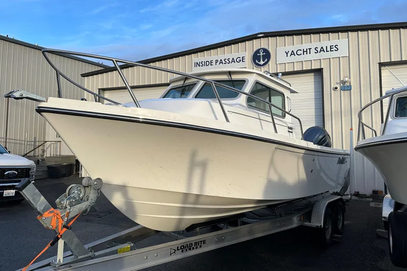The Image of 2025 Parker 2420 Sport Cabin boat on trailer at yacht sales dealership. - 0