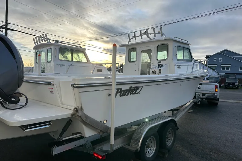 Slide: The Image of 2025 Parker 2420 Sport Cabin boat on trailer at sunset. - 4