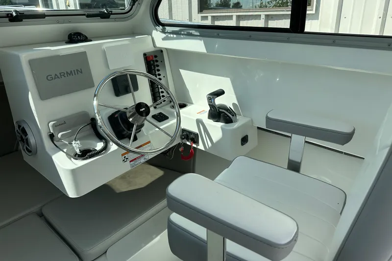 Slide: The Image of 2025 Parker 2420 Sport Cabin interior with Garmin navigation and modern steering controls. - 7