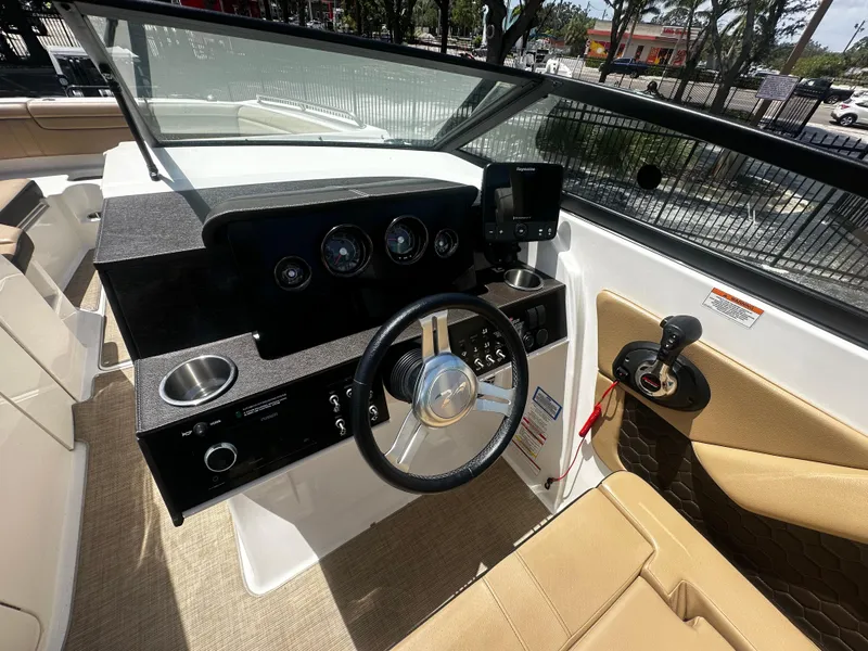 Slide: The Image of 2019 Sea Ray SDX 290 boat cockpit with steering wheel and control panel. - 5