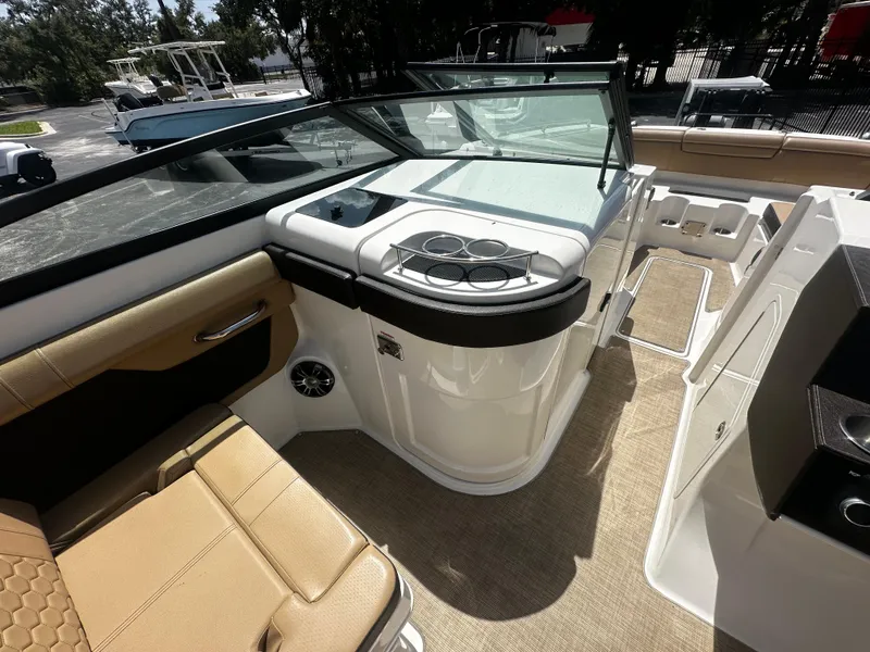 Slide: The Image of 2019 Sea Ray SDX 290 boat interior with tan seating and cup holders. - 6