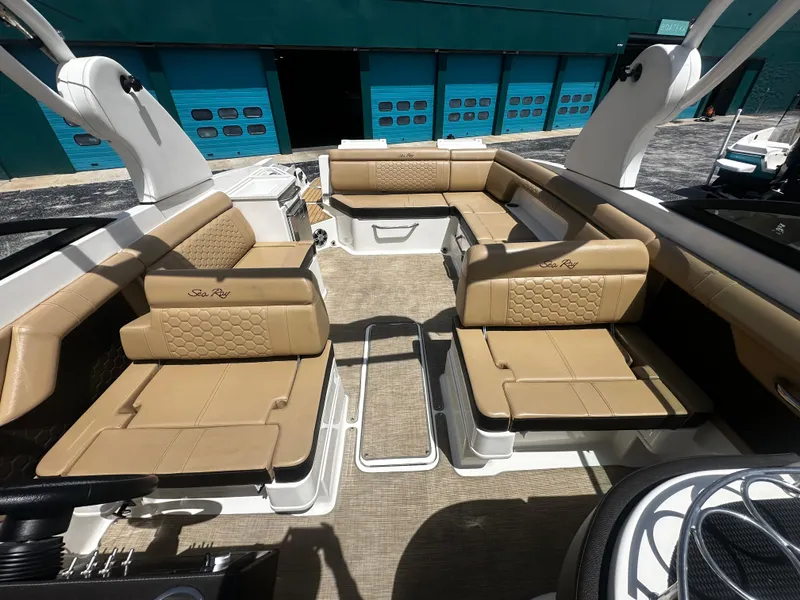 Slide: The Image of 2019 Sea Ray SDX 290 boat interior with tan leather seating and modern design. - 7