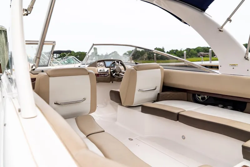 Slide: The Image of 2013 Regal 2700 ES Bowrider interior with beige seating and sleek dashboard design. - 11