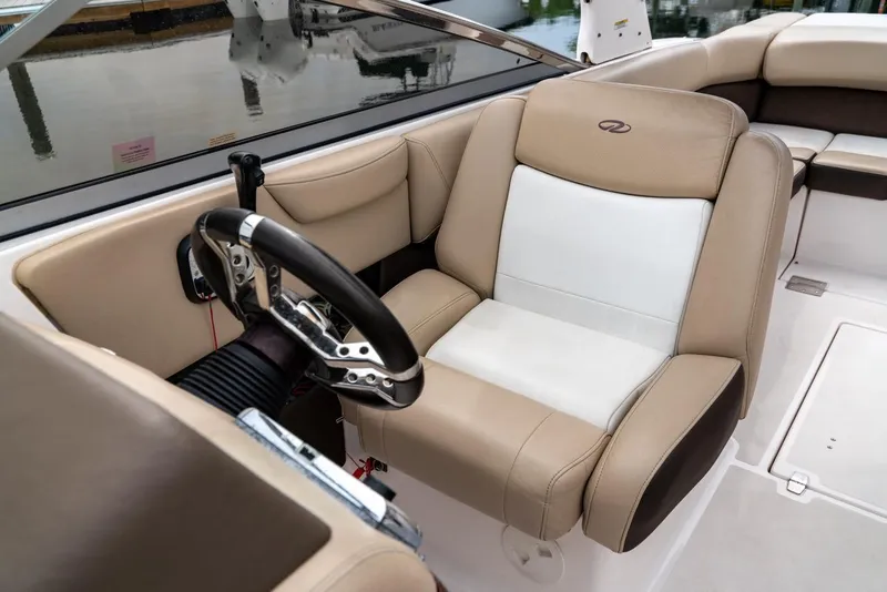 Slide: The Image of 2013 Regal 2700 ES Bowrider interior with beige and white captain's seat and steering wheel. - 12