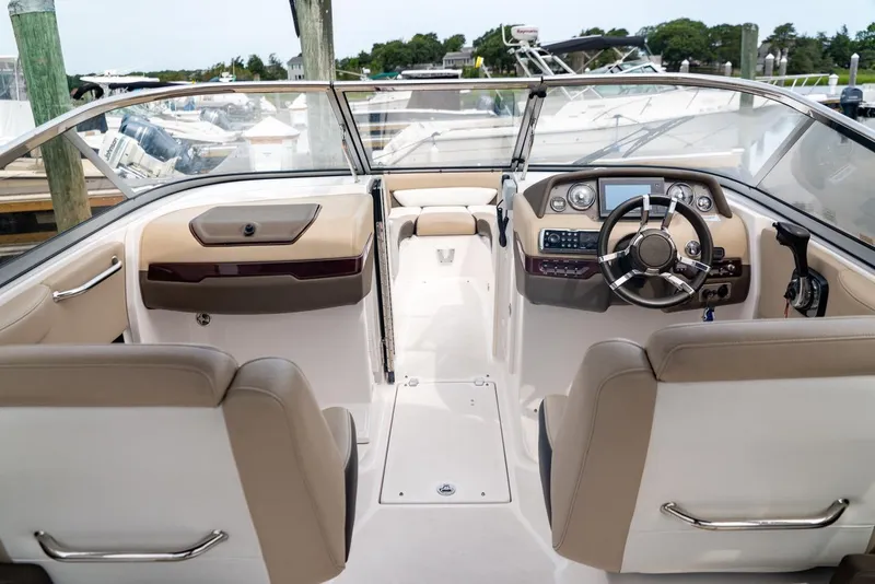 Slide: The Image of 2013 Regal 2700 ES Bowrider interior with steering wheel and dashboard controls. - 16
